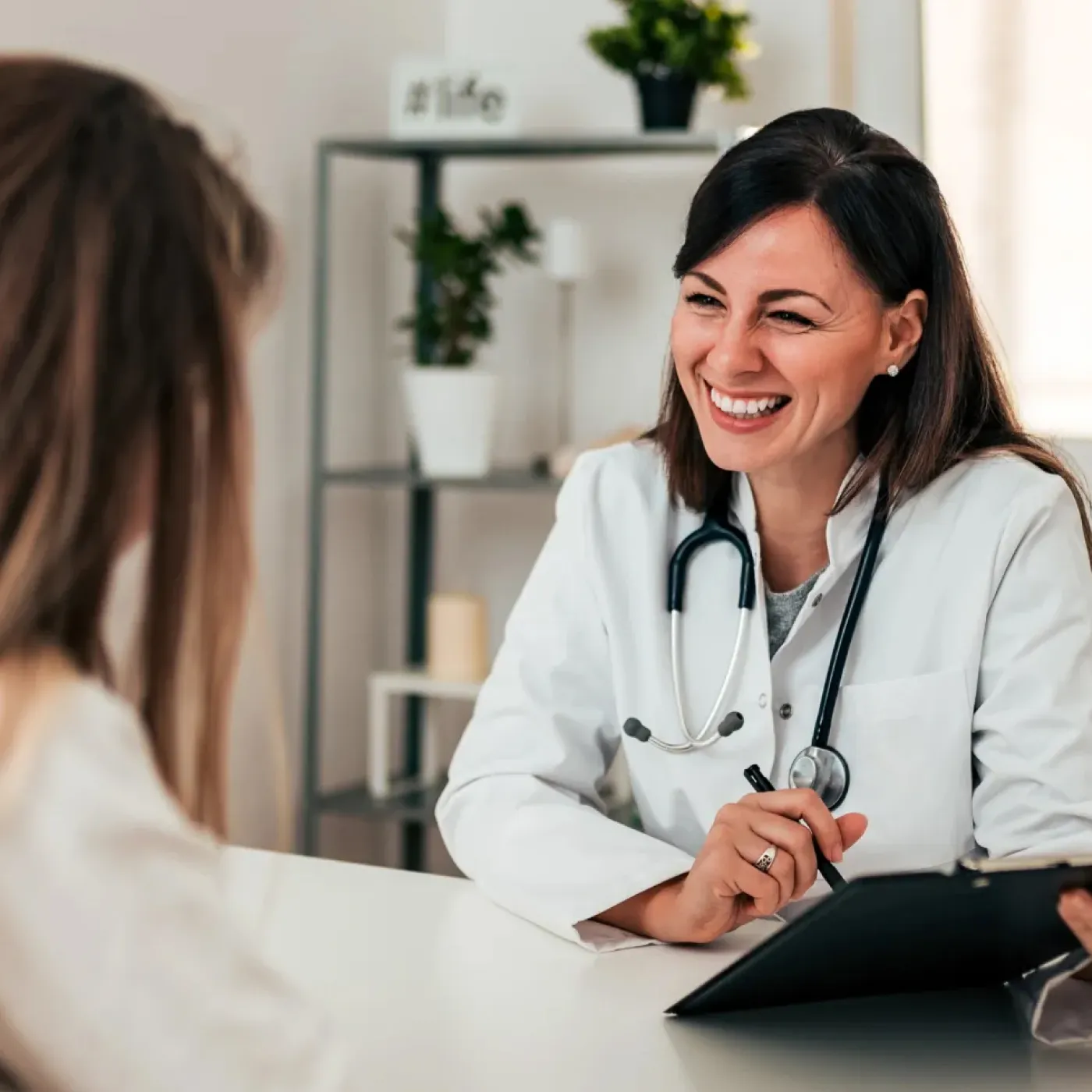 Primary care physician with her patient talking about pelvic health.