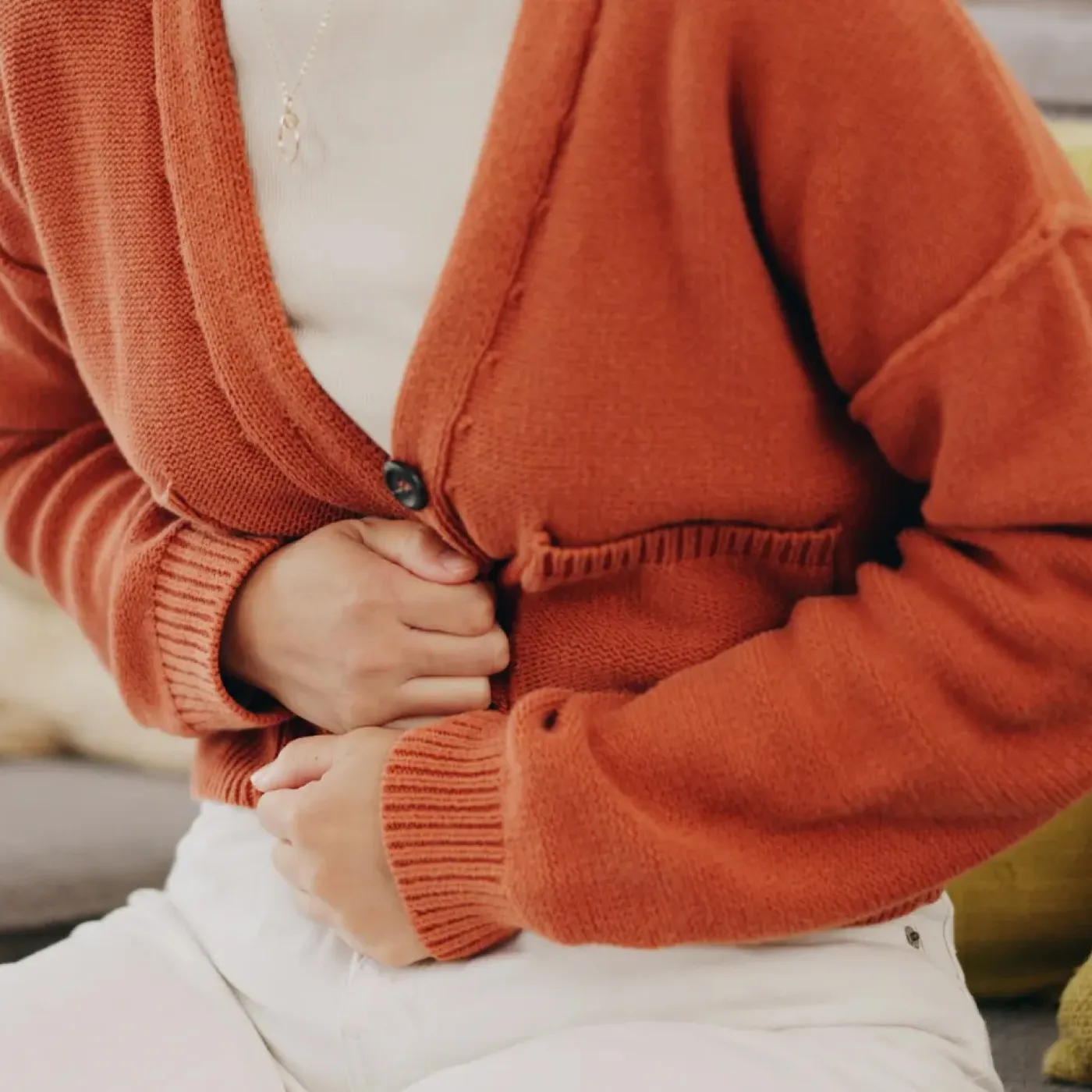 Woman with IBS and pelvic floor dysfunction experiencing bloating.