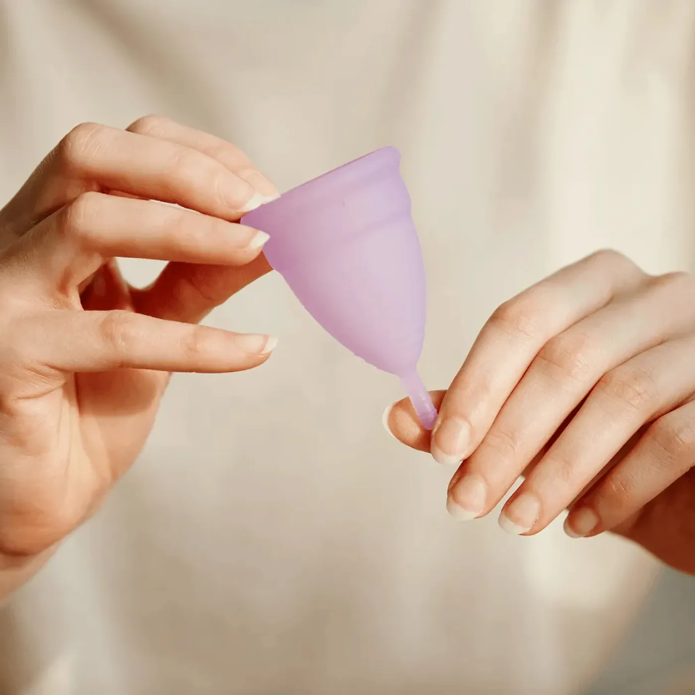 Woman holding a menstrual cup.
