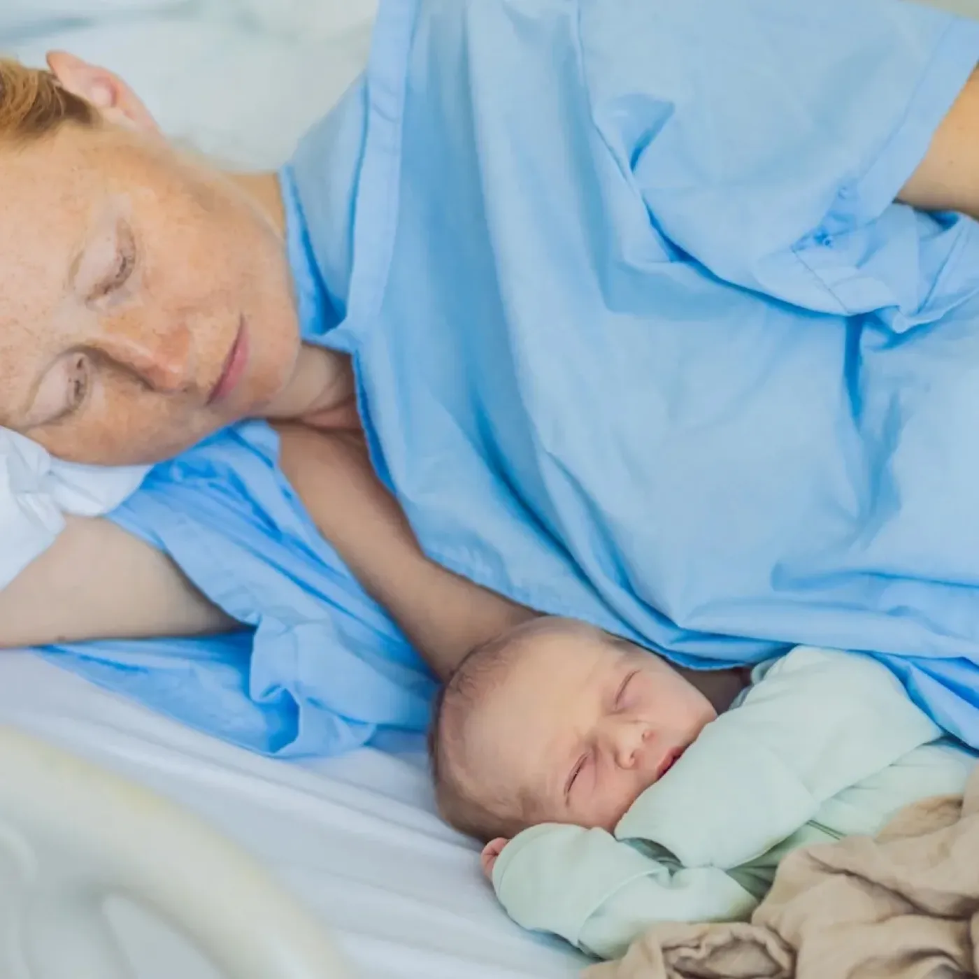 A postpartum athlete in the hospital with her newborn.
