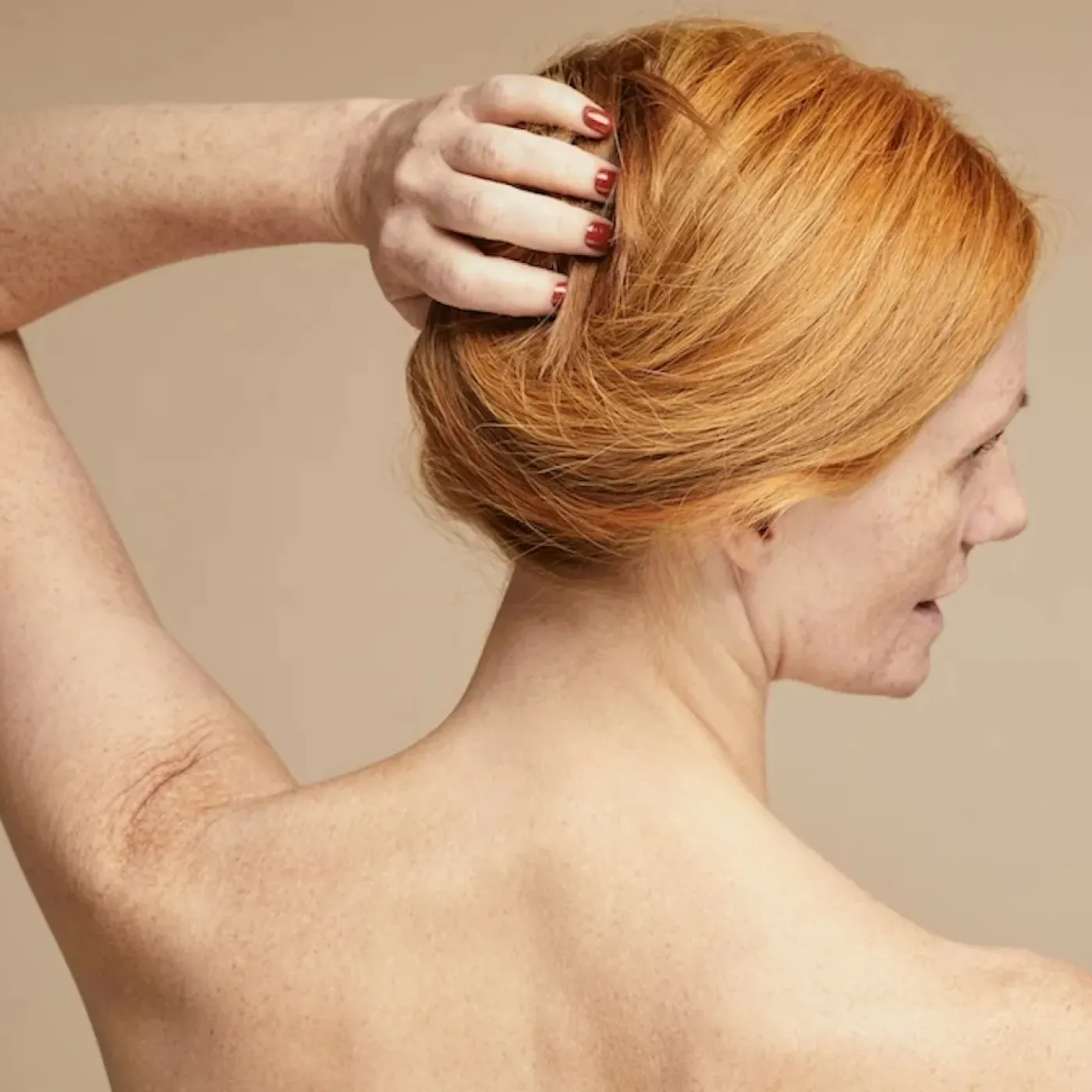 A woman in menopause unable to move her frozen shoulder.