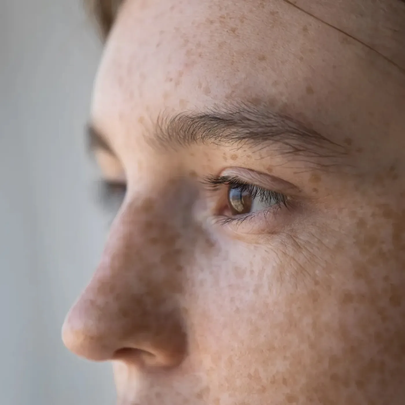 A zoomed-in portrait of a woman dealing with pelvic pain due to stress and anxiety.