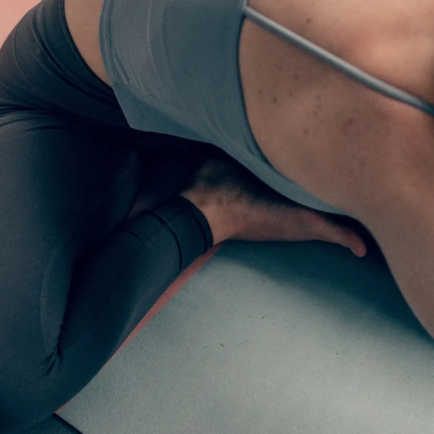 A woman with pelvic floor and hip pain stretching out her hips.