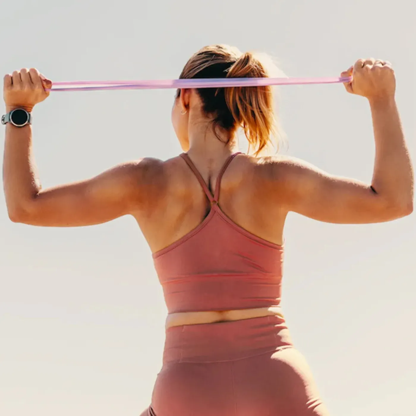 A woman holding her lower back.