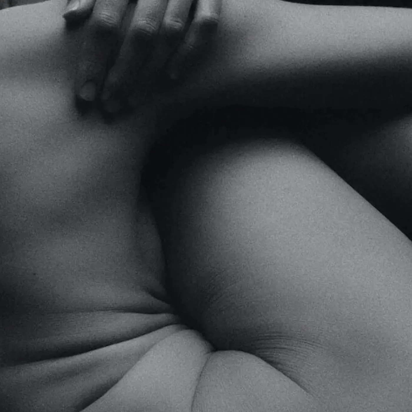 Woman in pain holding her lower back.