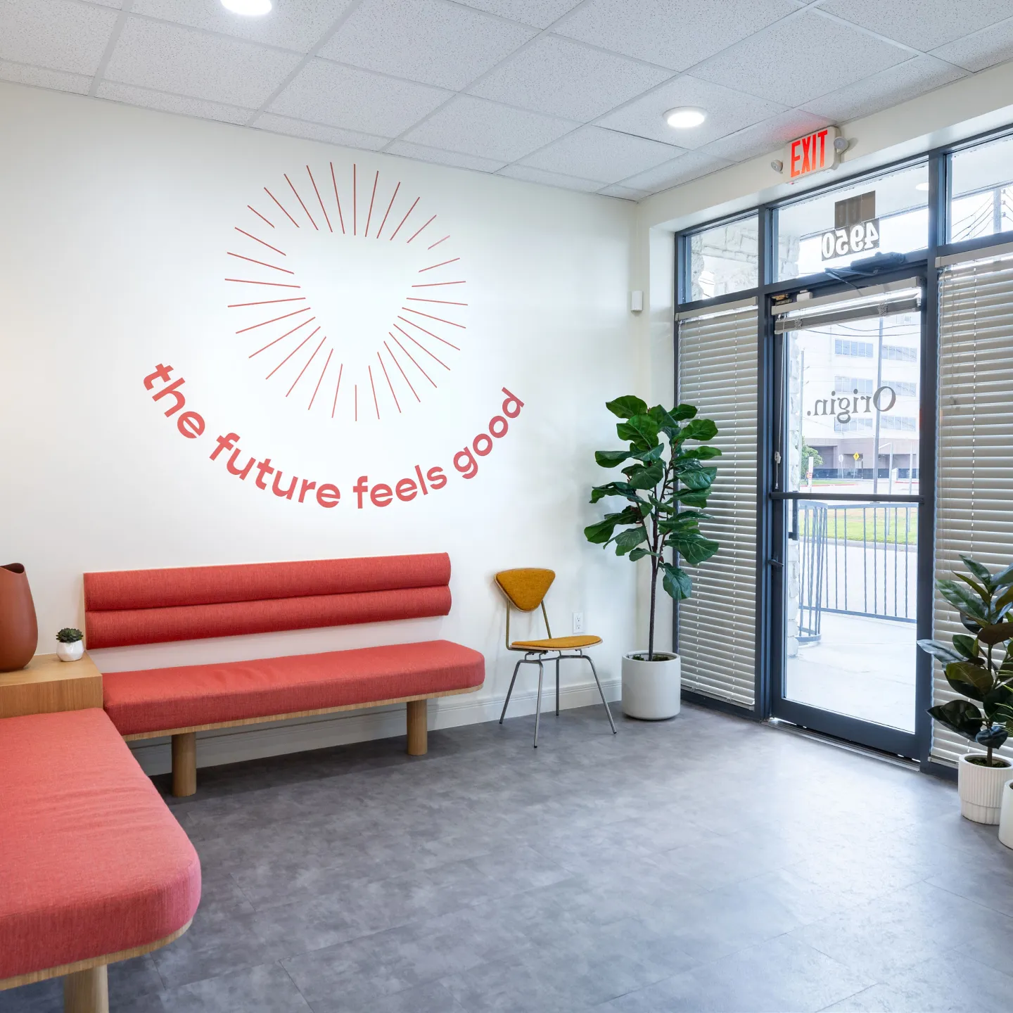 A modern waiting room in Origin clinic, featuring comfortable seating and bright, welcoming decor.