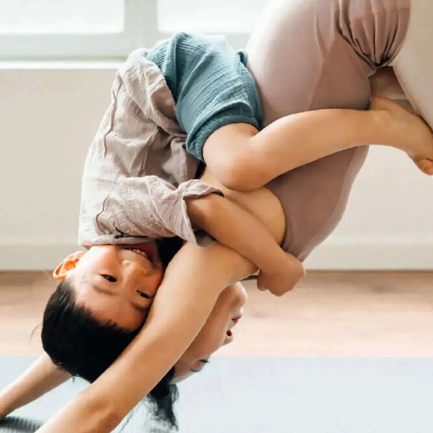 Woman doing yoga with child.