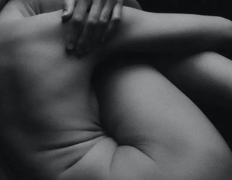 Woman in pain holding her lower back.