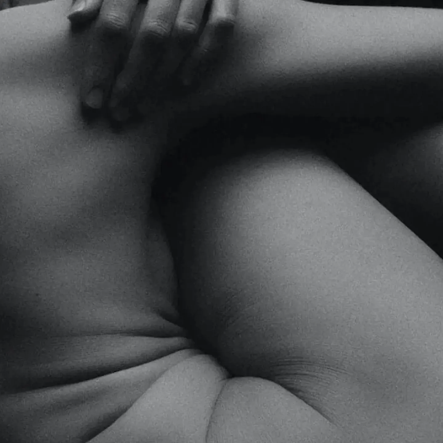 Woman in pain holding her lower back.