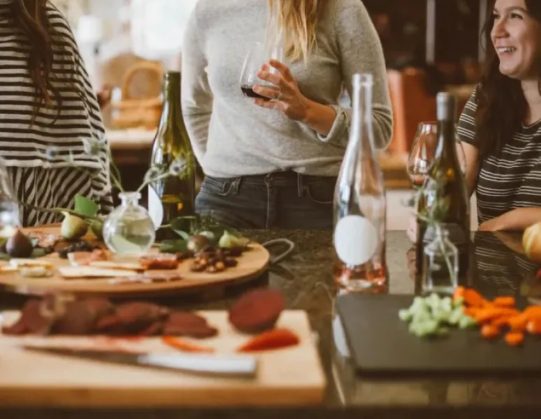Women talking about their pelvic floors at a holiday gathering.