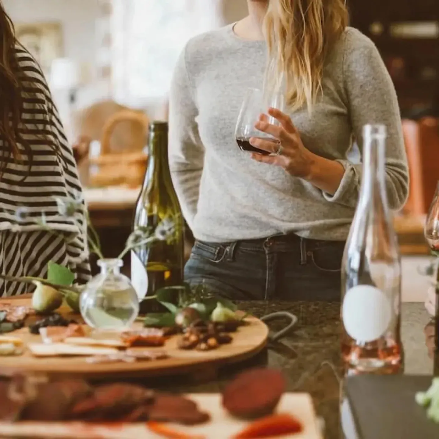 Women talking about their pelvic floors at a holiday gathering.