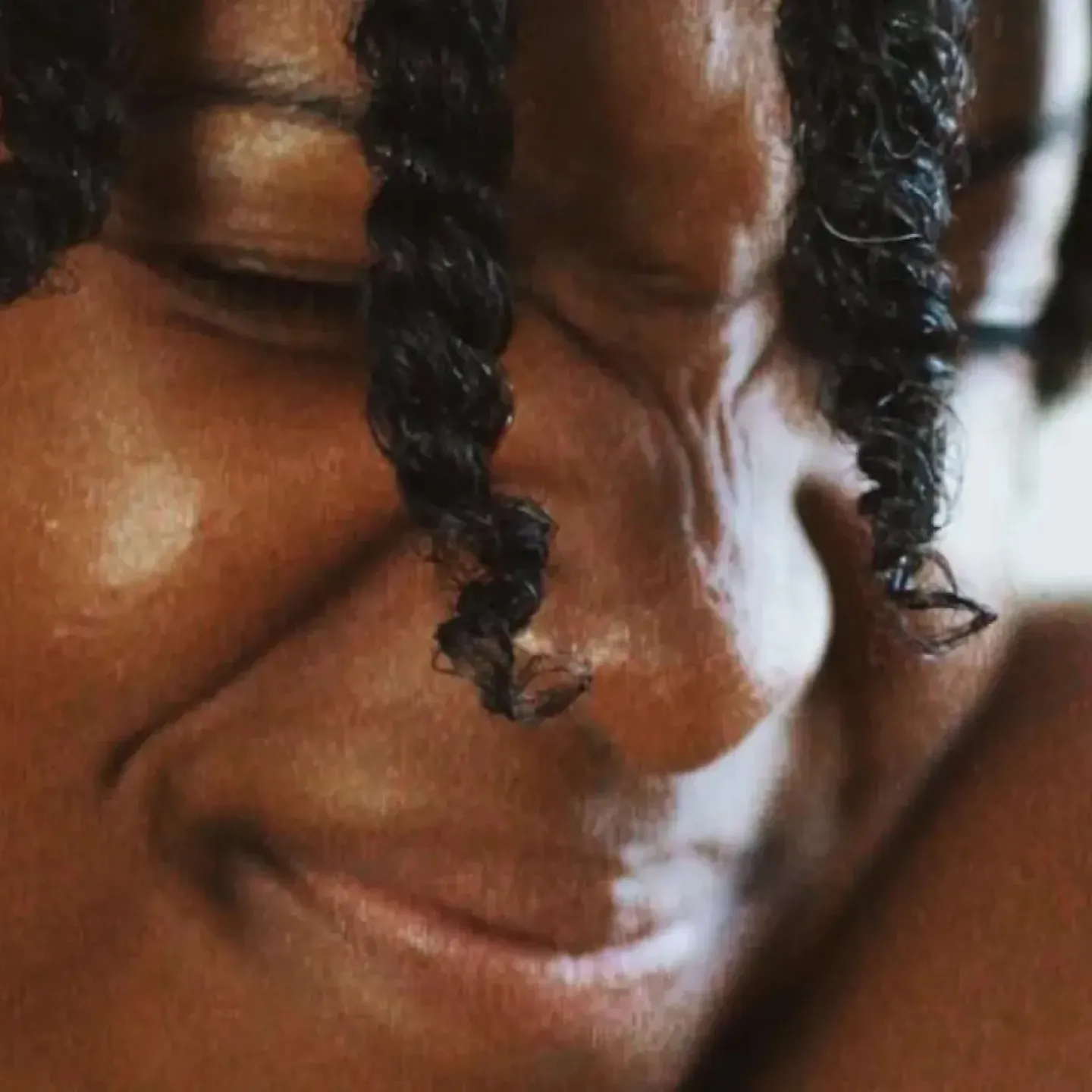 A woman with stress urinary incontinence laughing after getting off of a trampoline.