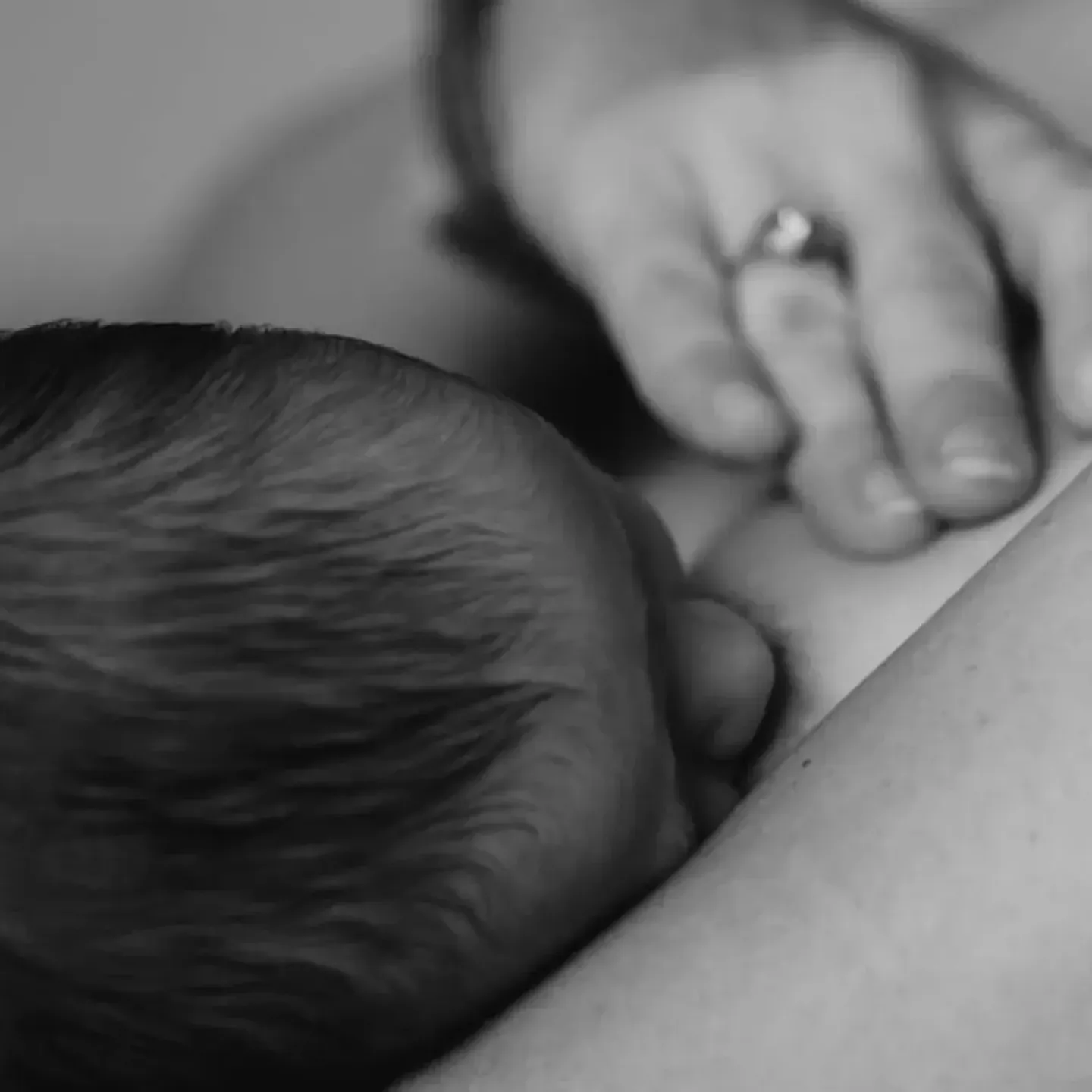 A woman holding her postpartum breasts.