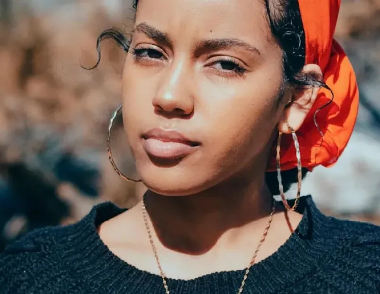 A concerned looking young Black woman.