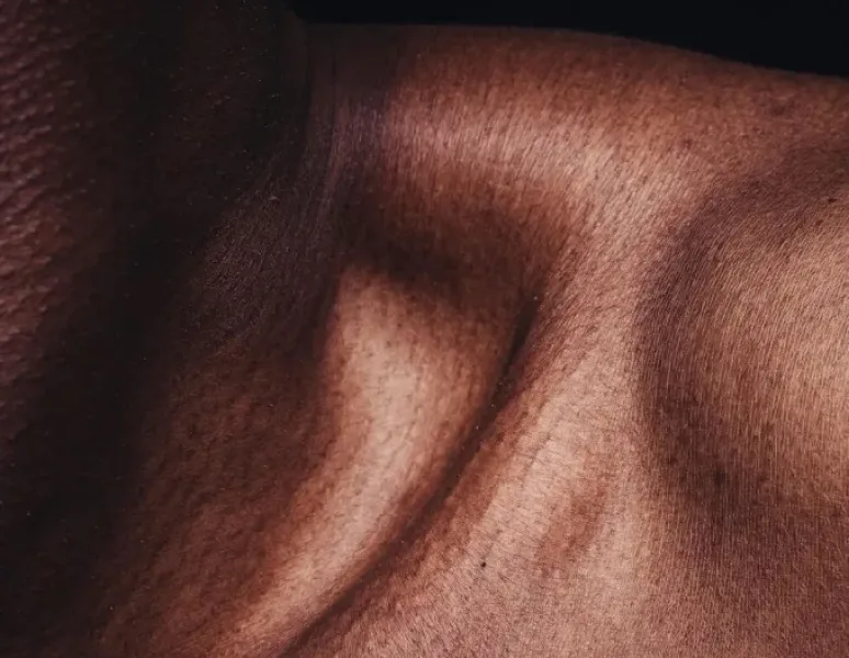 A close up photo of a woman's collarbone showing the texture of her skin.