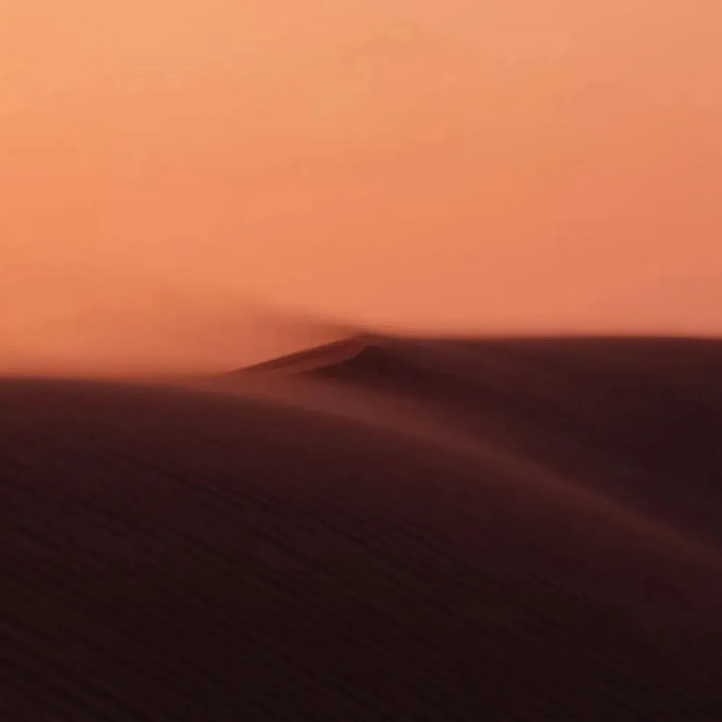 A photograph of sand dunes under a red sky to represent a dry vulva an vagina for a story on vaginal dryness before menopause.