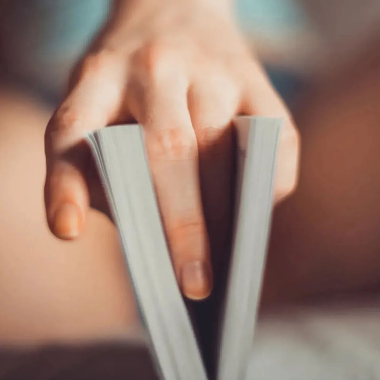 A woman holding a book between her legs to symbolize her vulva and sexuality.