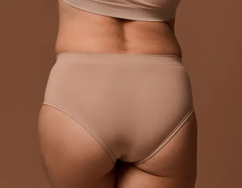 A woman's low back in the first trimester of pregnancy.