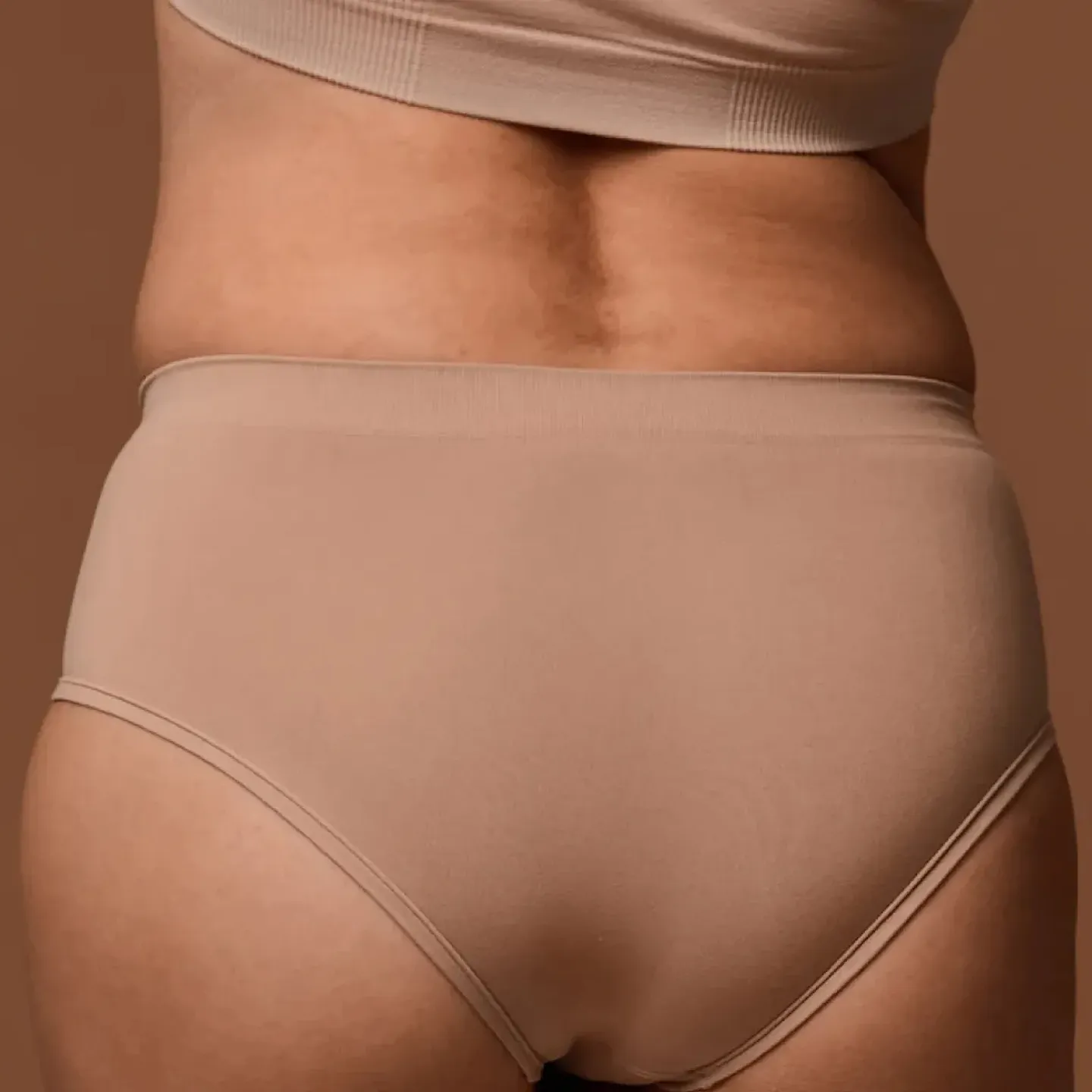 A woman's low back in the first trimester of pregnancy.