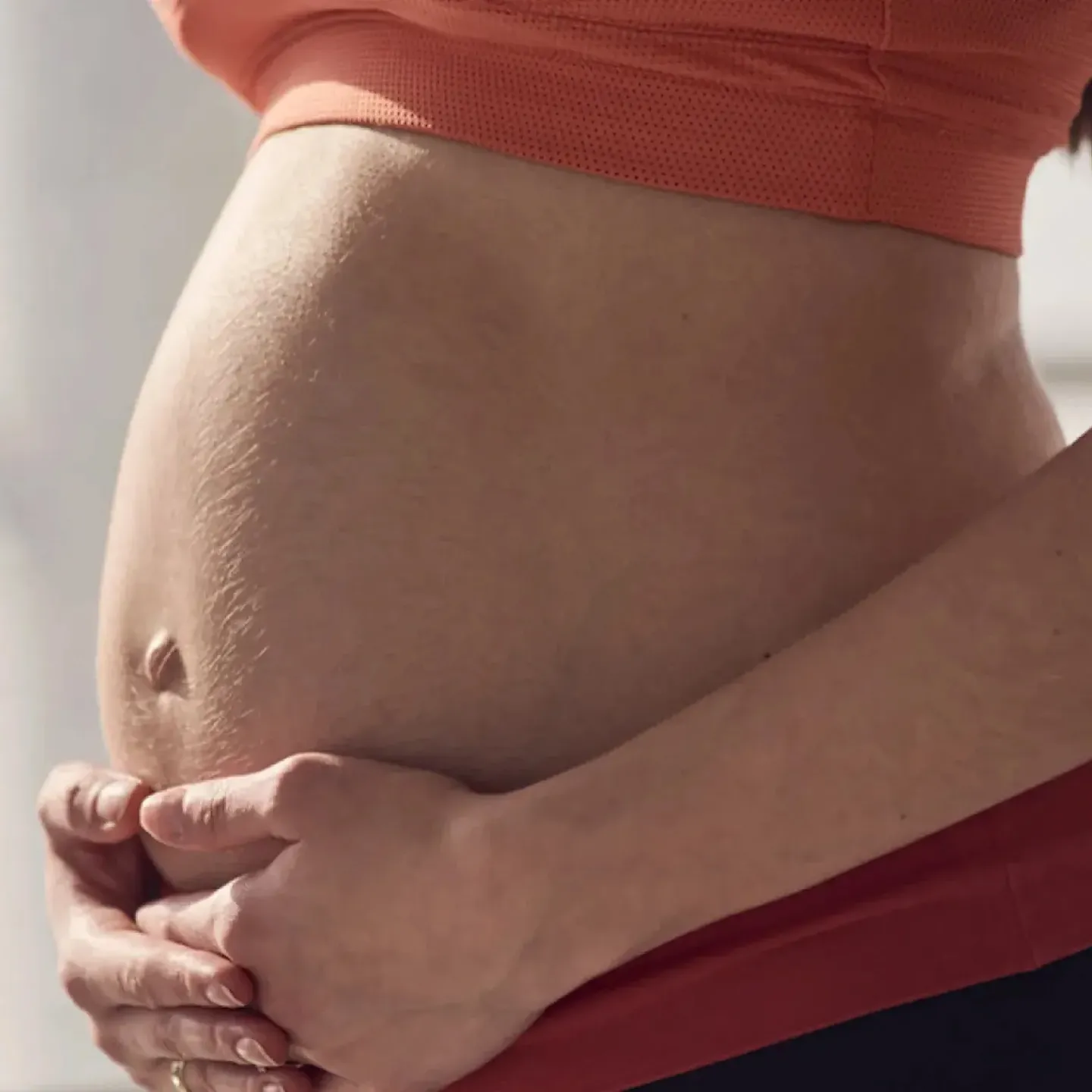 A pregnant woman in her third trimester doing yoga to relieve low back pain.