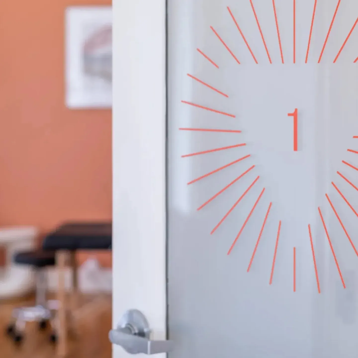 Clinic doors opening into the spa-like treatment rooms at Origin Physical Therapy.