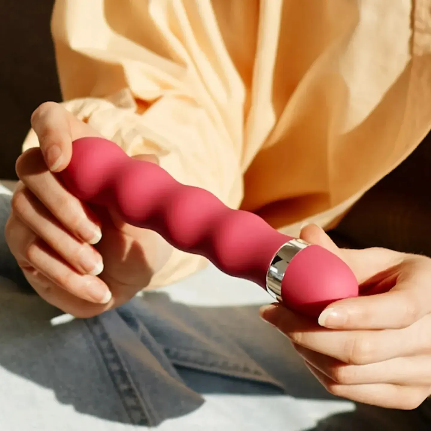 A woman holding a pelvic floor strengthening kegel trainer.