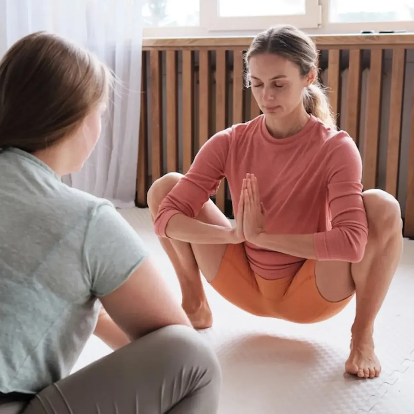 A woman doing yoga to stretch her pelvic floor.