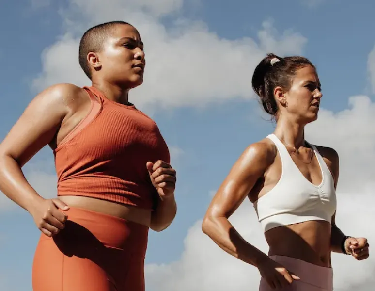 Two women running side by side for a story on pelvic floor dysfunction for runners.