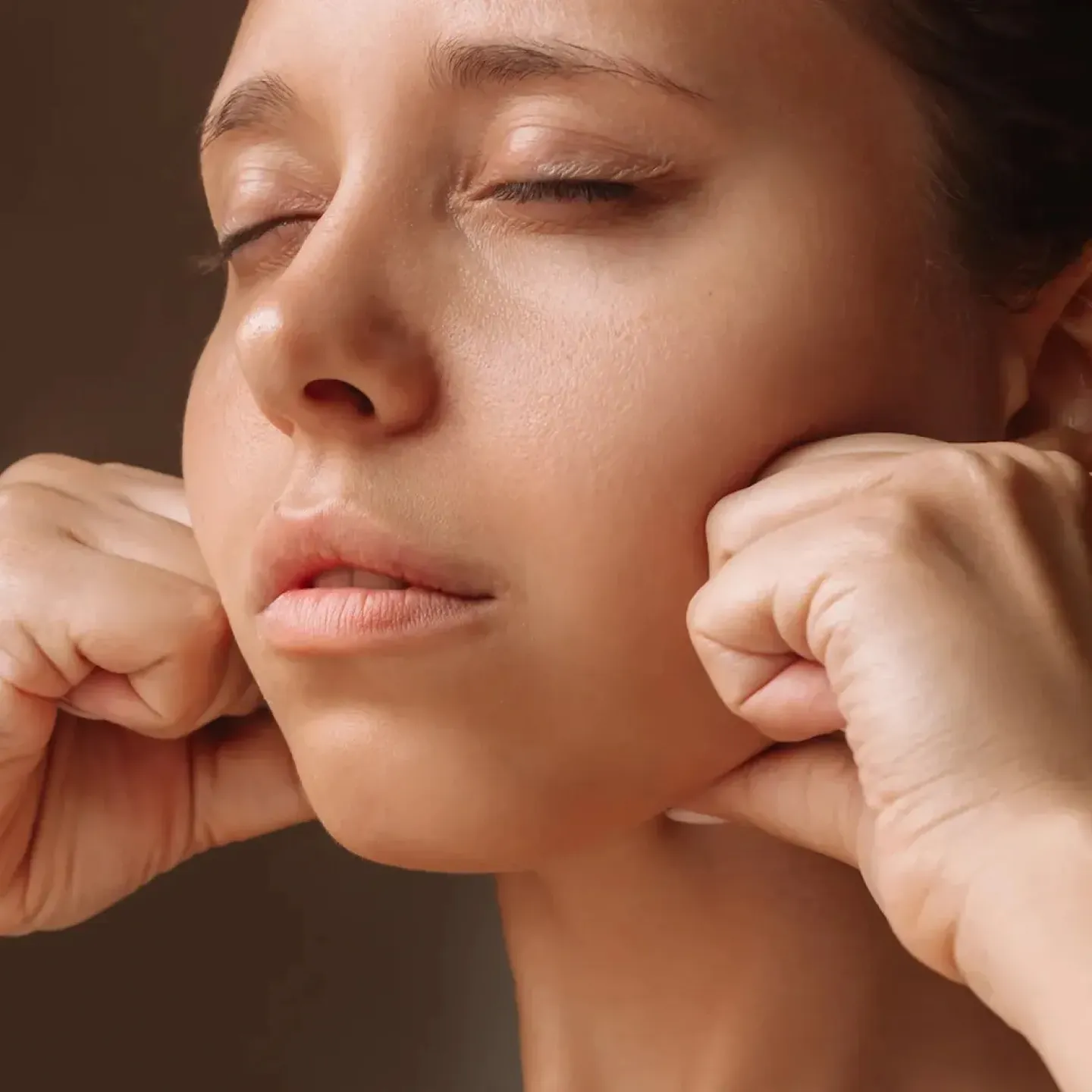 A woman getting jaw massage from a pelvic floor Physical Therapist.