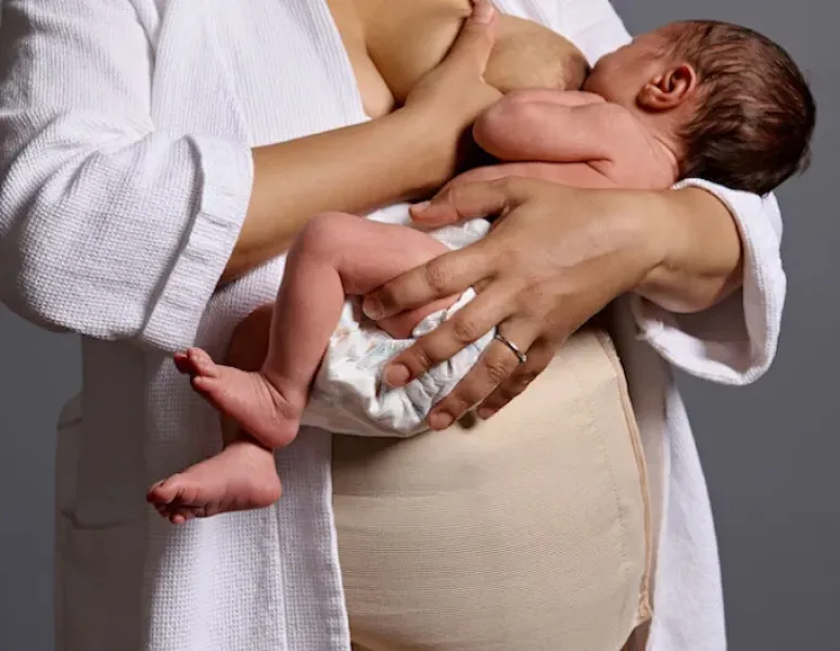 A woman breastfeeding her baby after a c-section delivery.