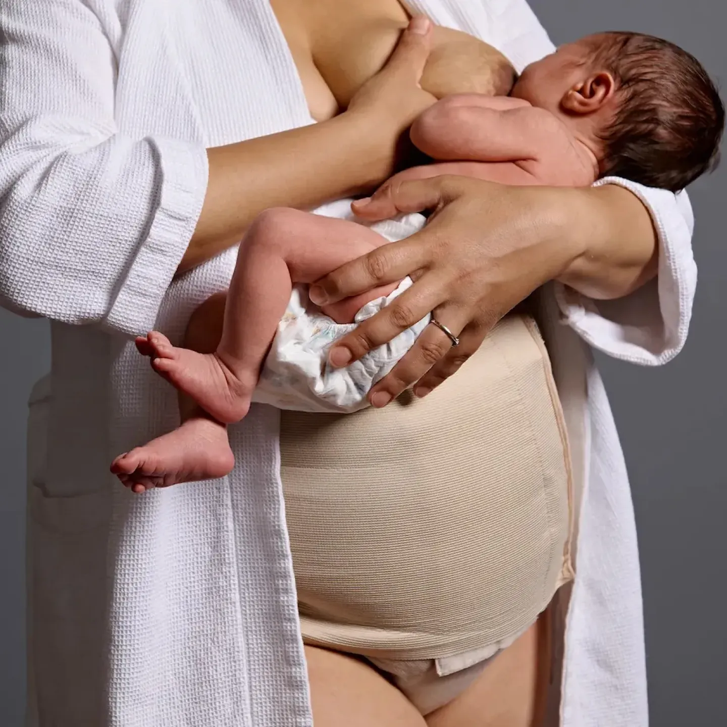 A woman breastfeeding her baby after a c-section delivery.