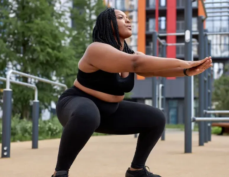 A woman doing pelvic floor exercises for bladder leaks at the park.