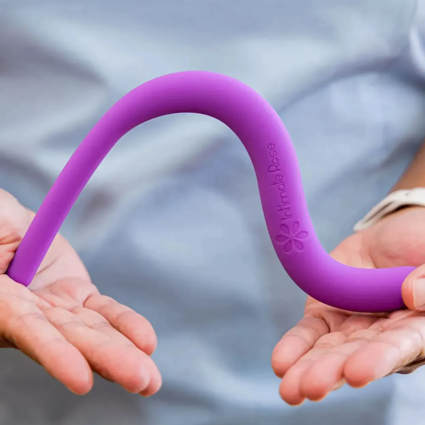 A pelvic floor PT at Origin holding a purple pelvic wand by Intimate Rose.