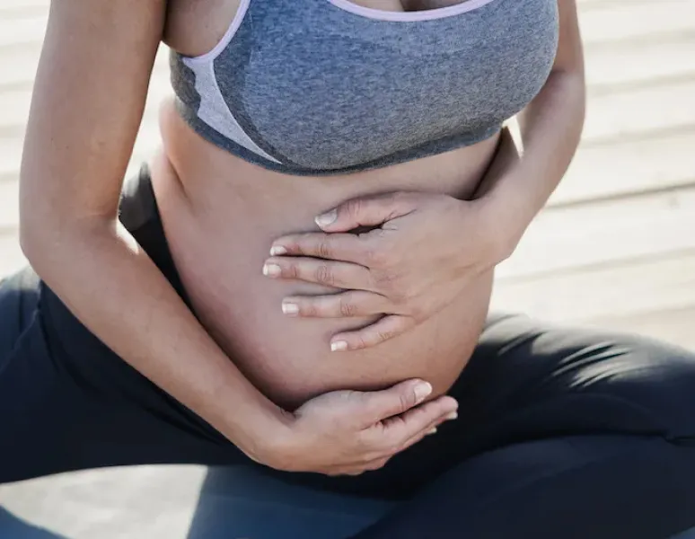 A pregnant woman exercising her pelvic floor.