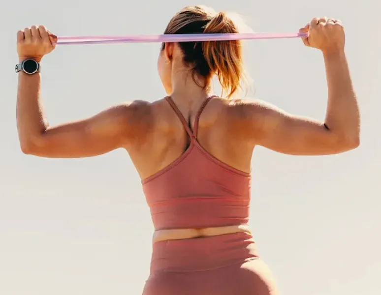 A woman holding her lower back.