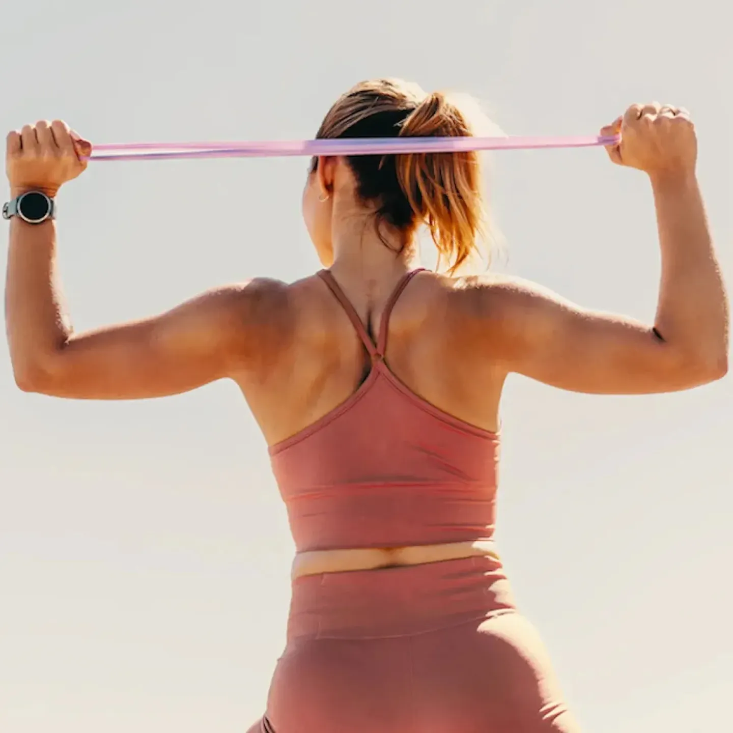 A woman holding her lower back.