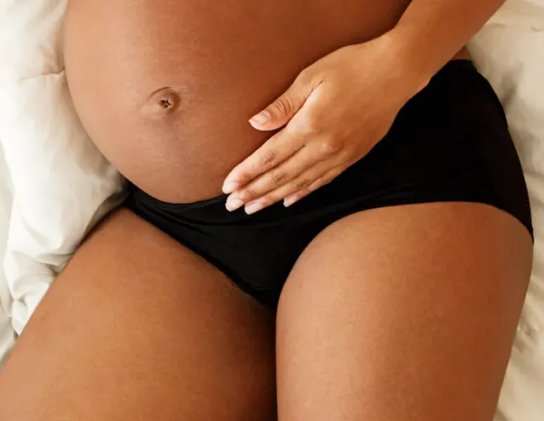 A pregnant woman in her second or third trimester with pregnancy tailbone pain.