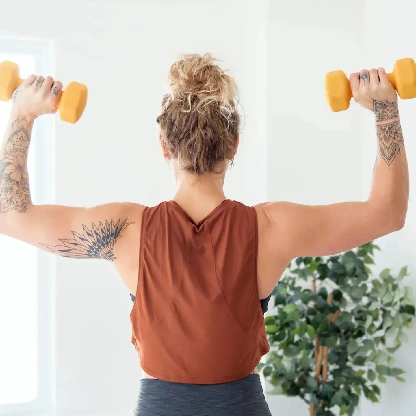 A woman in perimonopause lifting weights.