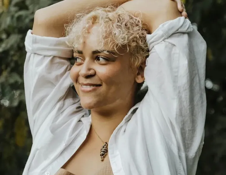 A women with menopause joint pain holding her elbow.
