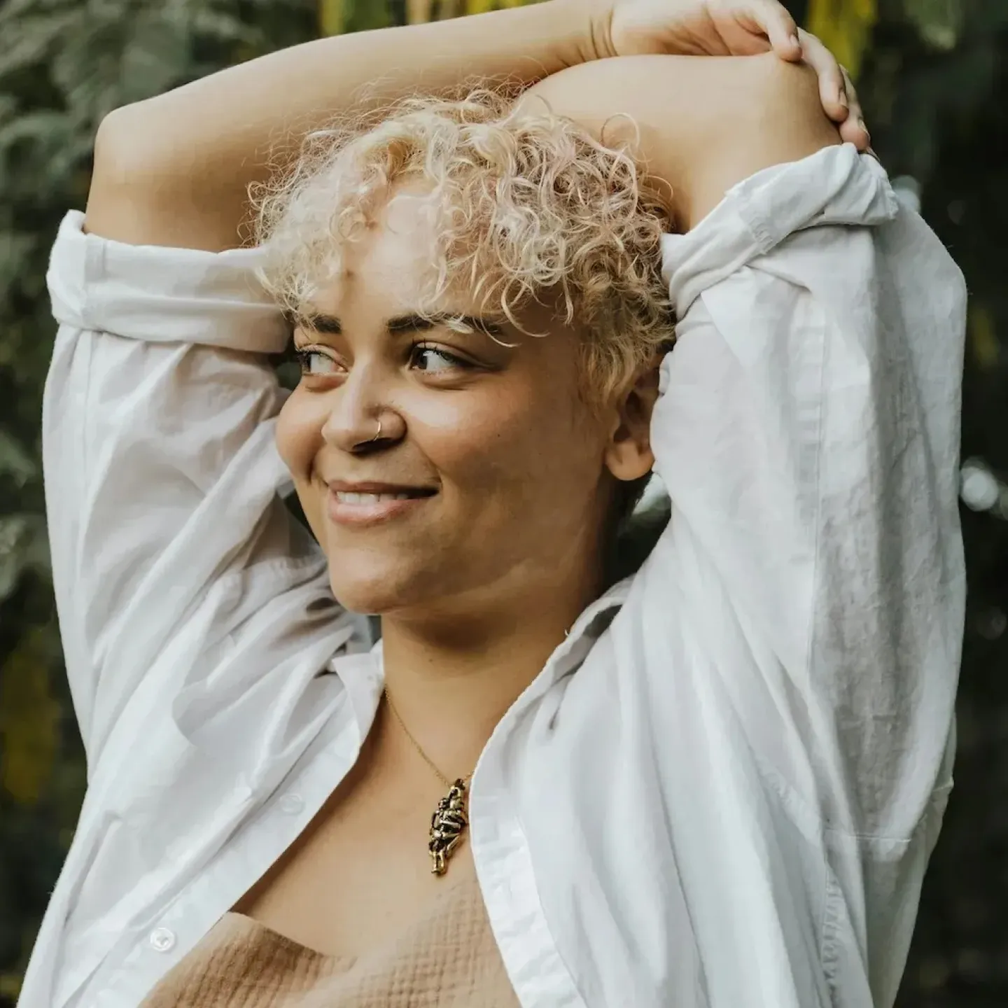 A women with menopause joint pain holding her elbow.