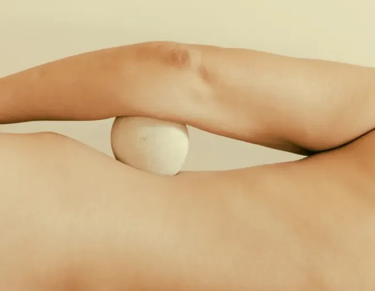 A woman holding her ankle.