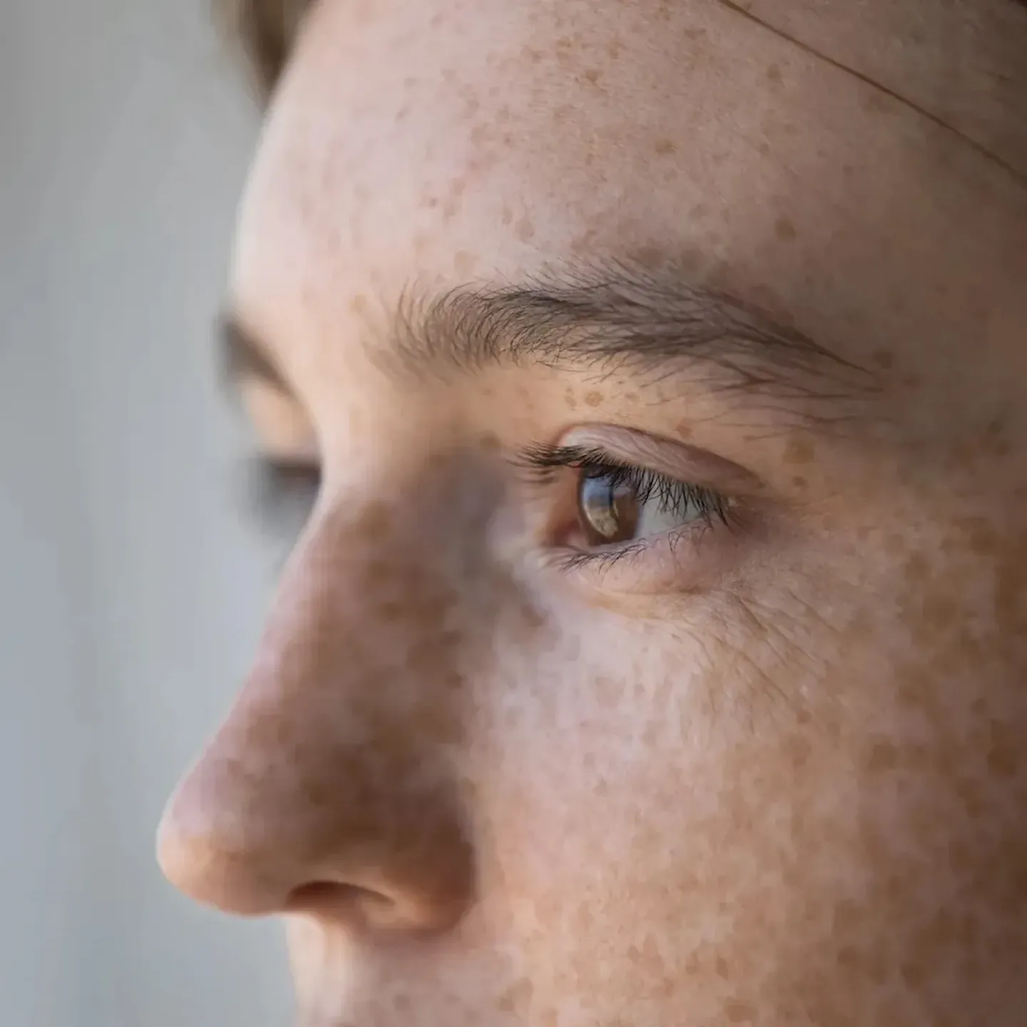A zoomed-in portrait of a woman dealing with pelvic pain due to stress and anxiety.