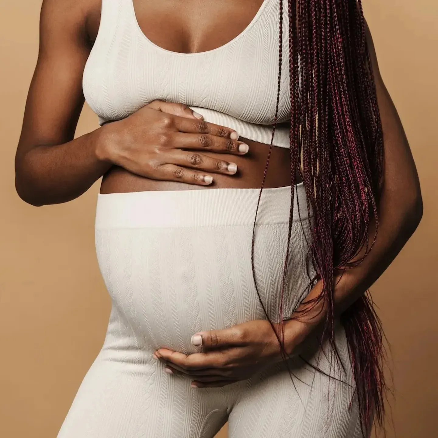A pregnant woman whose pelvic floor is about to go through the strain of labor and childbirth.