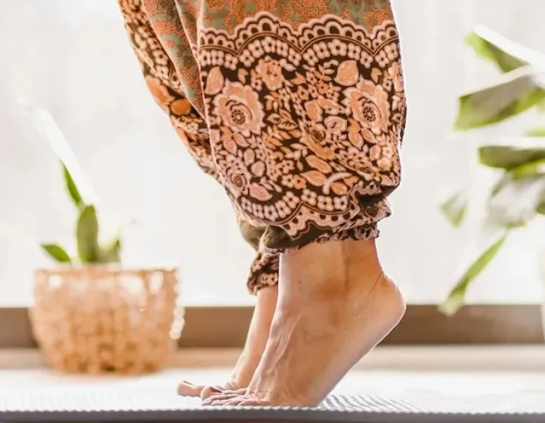 A person with postpartum foot pain stretches out her feet.