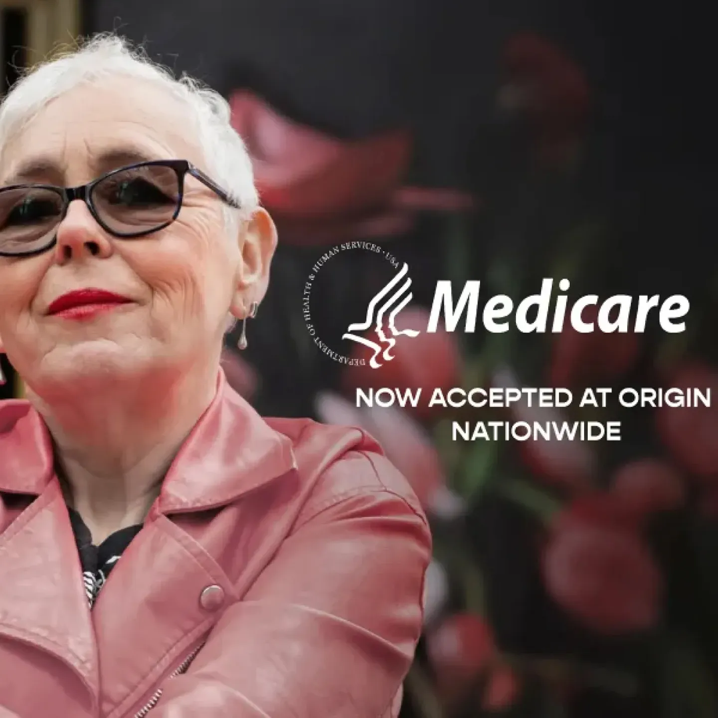 A older woman with close-cropped hair in a leather jacket happy to be able to use Medicare at Origin.