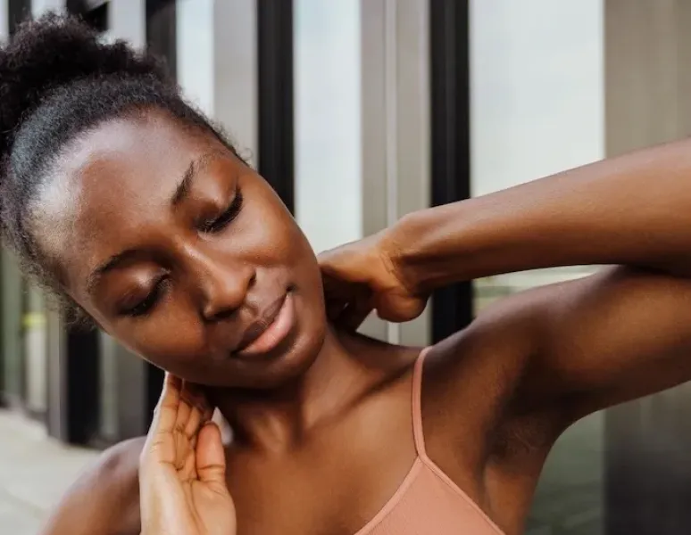 A woman using physical therapy techniques to ease her headache pain.