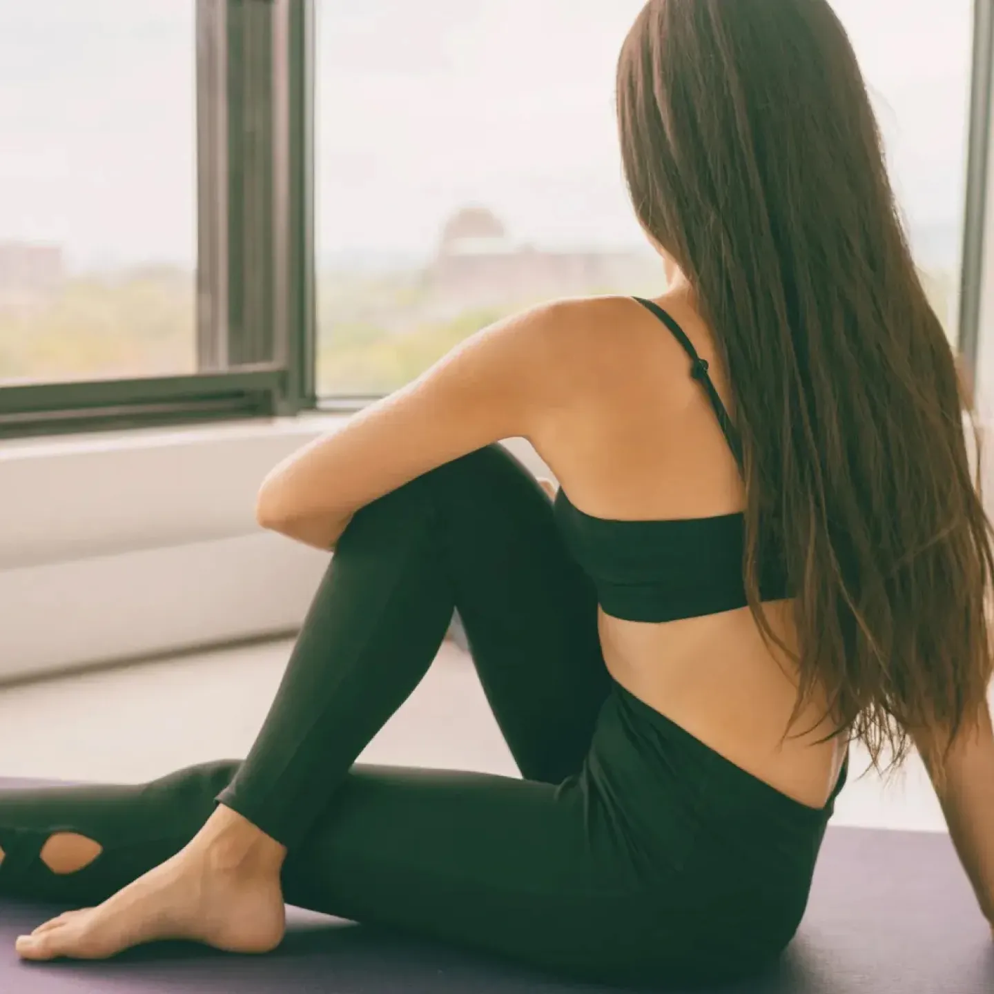 Yoga stretch exercise at home fit happy woman stretching lower back for piriformis syndrome relaxing at home. Floor easy workout for home.