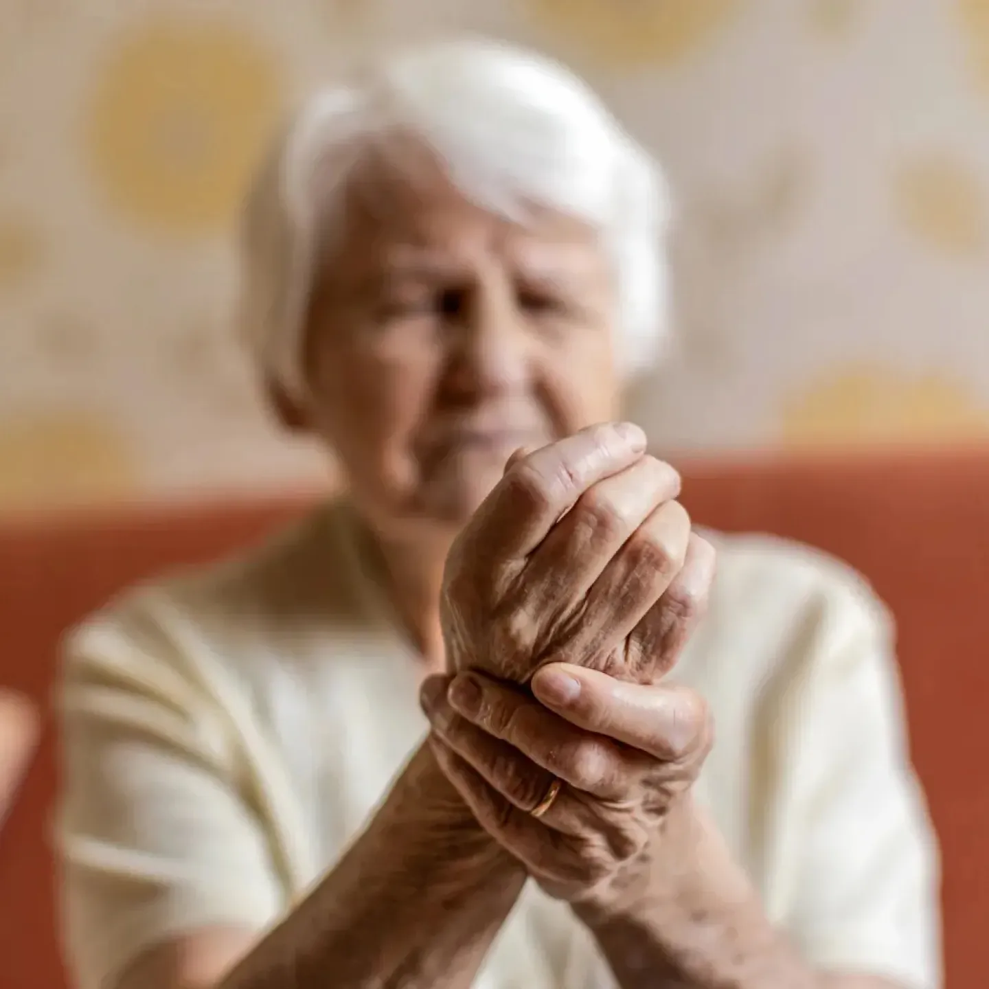 Senior woman holding her sore wrist.