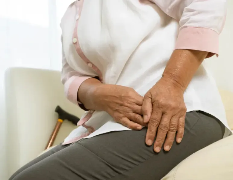 Woman with osteoporosis experiencing hip pain.