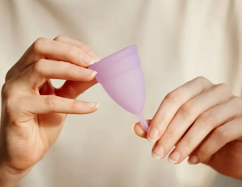 Woman holding a menstrual cup.